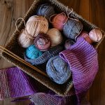 Accessories for knitting in basket ( yarn, needles) and scarf